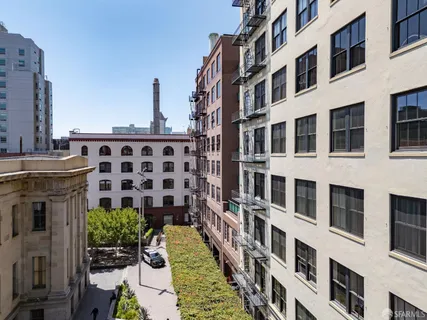 a very nice looking room with wooden floor and windows