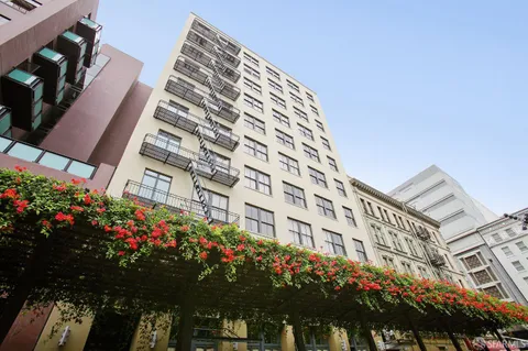 a front view of a building with traffic signal lights
