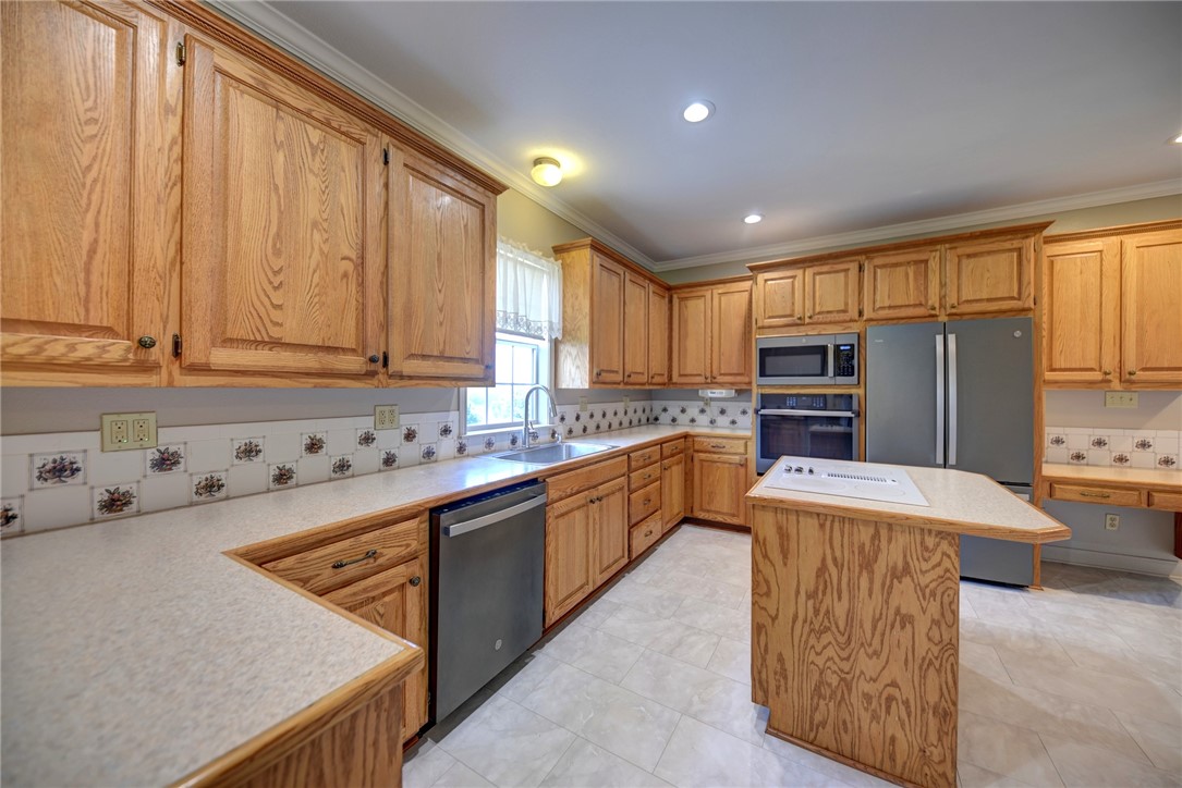 2375 FM 2935 Road North Brenham, TX 77833 - Photo 25 of 47 a kitchen with stainless steel appliances granite countertop a refrigerator a sink dishwasher a stove and white countertops with wooden floor