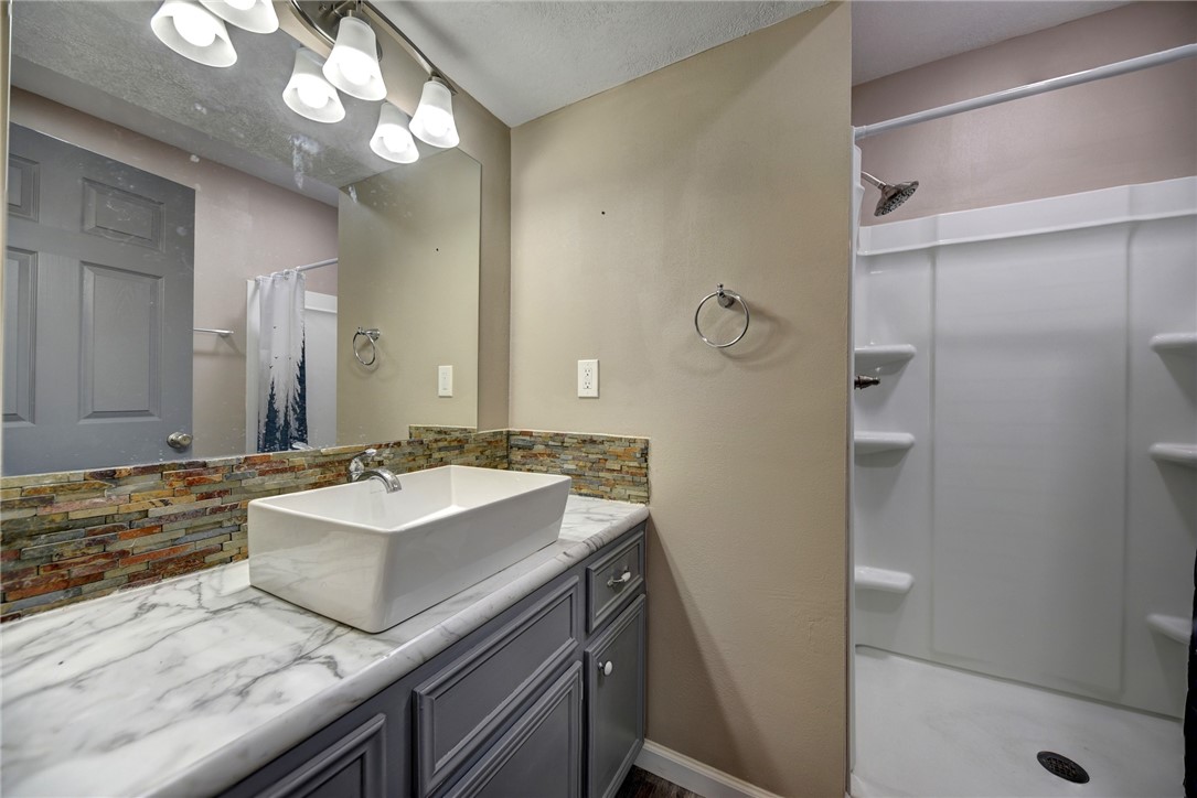 2375 FM 2935 Road North Brenham, TX 77833 - Photo 37 of 47 a bathroom with a sink a mirror and a shower