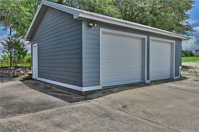 a view of small house with a garage