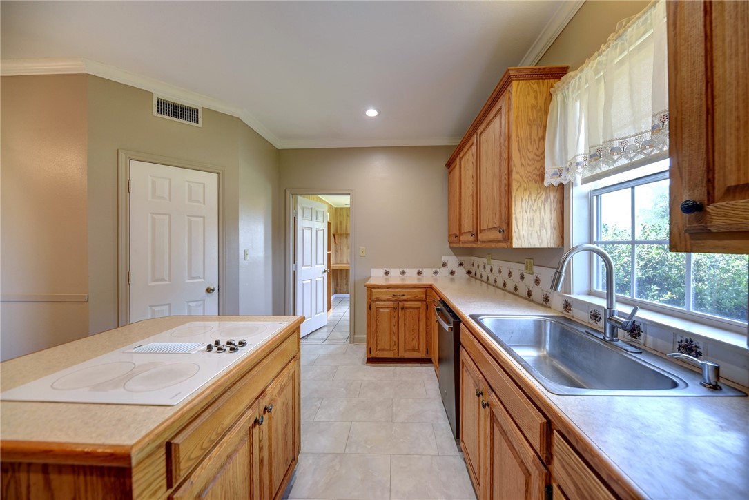 2375 FM 2935 Road North Brenham, TX 77833 - Photo 7 of 47 a kitchen with a sink stove and cabinets