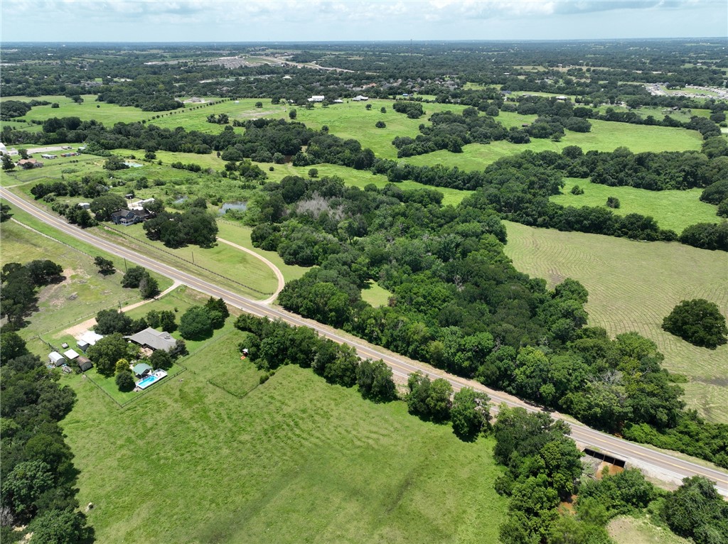 2375 FM 2935 Road North Brenham, TX 77833 - Photo 9 of 47 an aerial view of green landscape with trees houses and mountain view