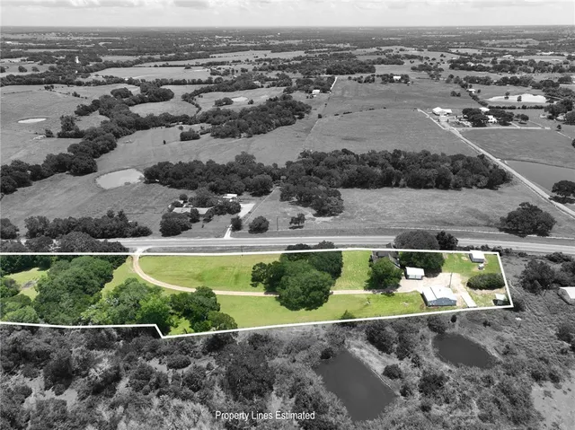 an aerial view of a house with a yard