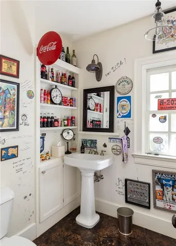 a bathroom with a sink a mirror and a toilet