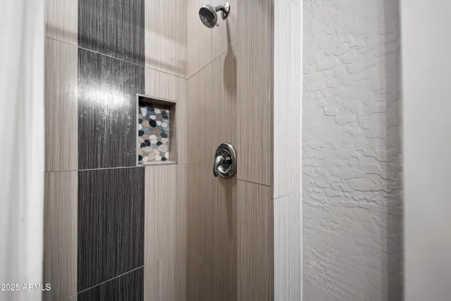 a bathroom with a shower and a sink