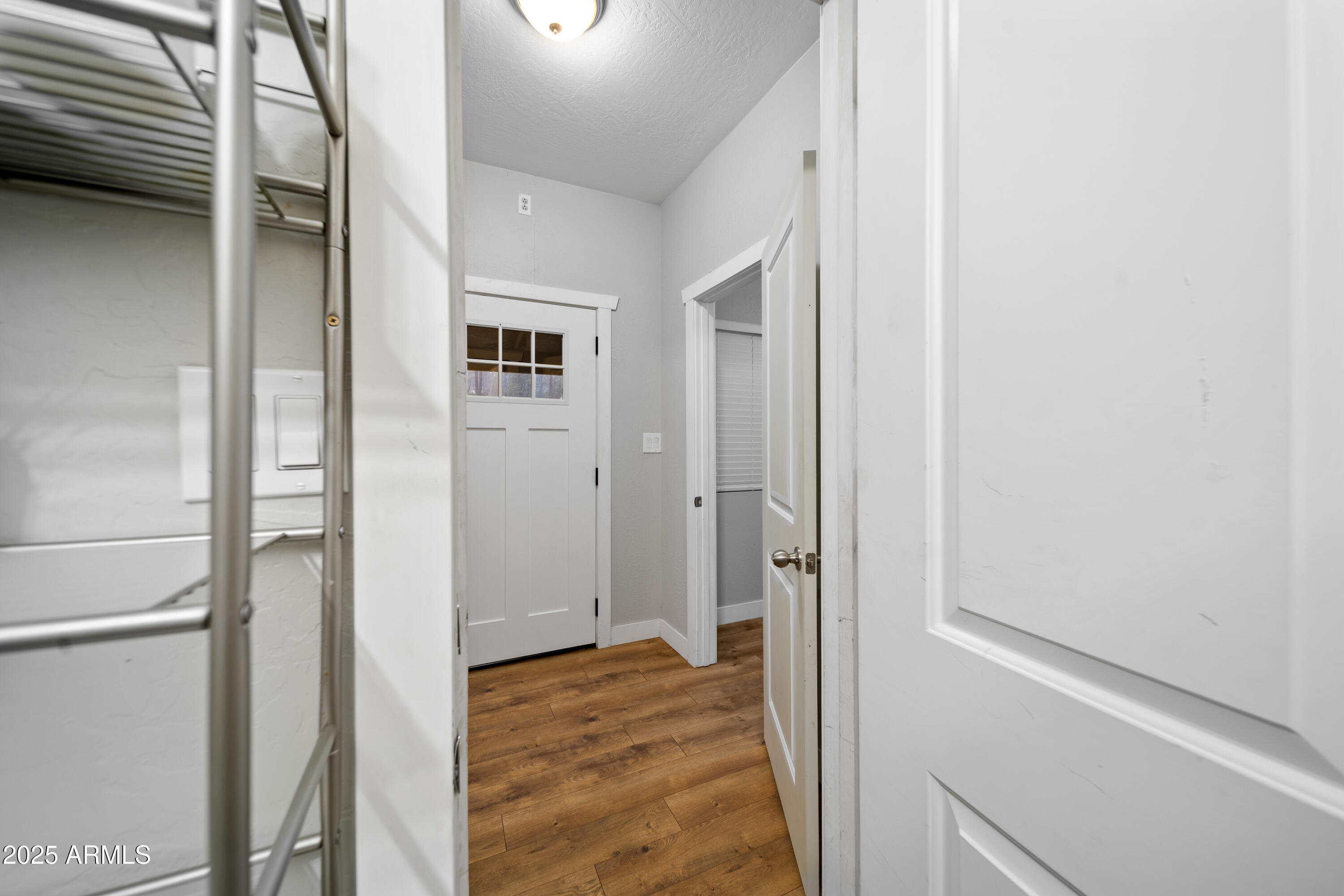 1898 Highway 260 Overgaard, AZ 85933 - Photo 19 of 38 a view of a hallway with wooden floor and a bathroom