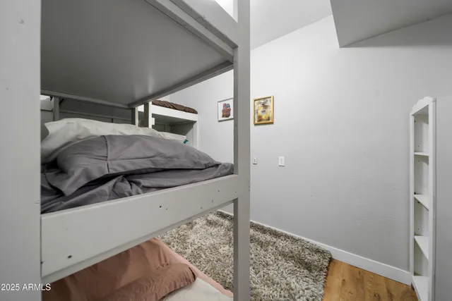 a bedroom with a bed and a potted plant