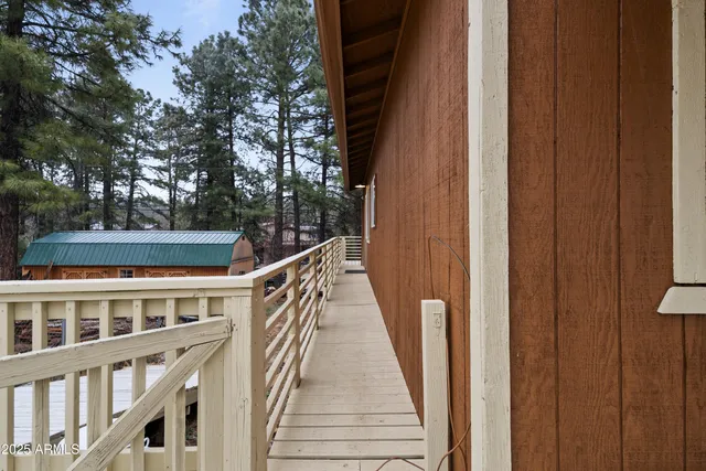 a view of balcony with wooden floor and fence