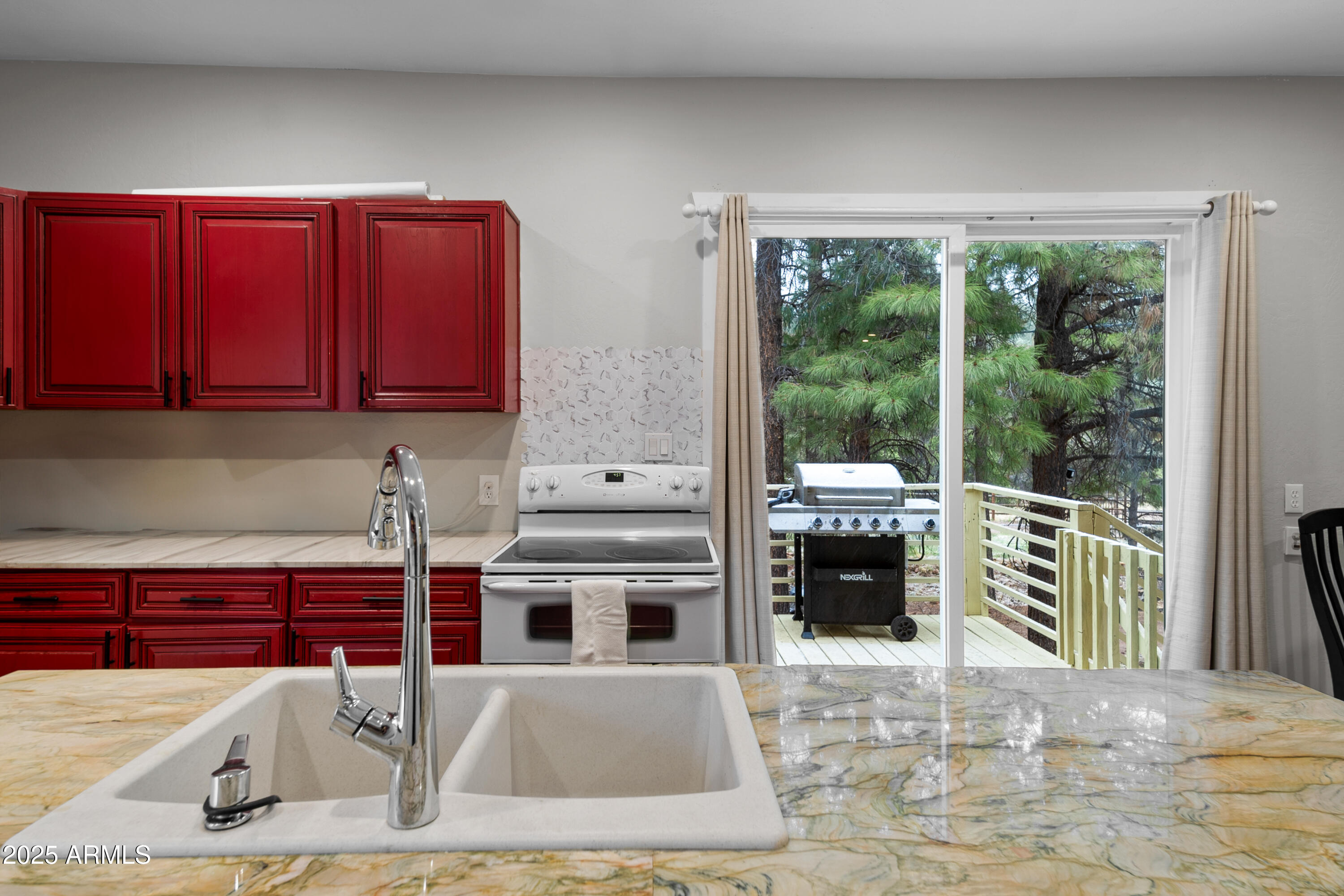 1898 Highway 260 Overgaard, AZ 85933 - Photo 5 of 38 a kitchen with stainless steel appliances granite countertop a stove a sink and a microwave