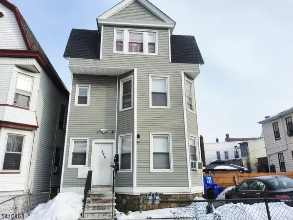 a front view of a residential houses with yard