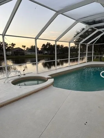 a view of a swimming pool with a yard