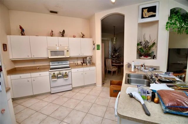a kitchen with a sink appliances and cabinets