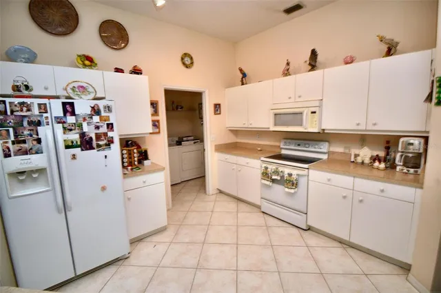 a kitchen with stainless steel appliances cabinets and white appliances