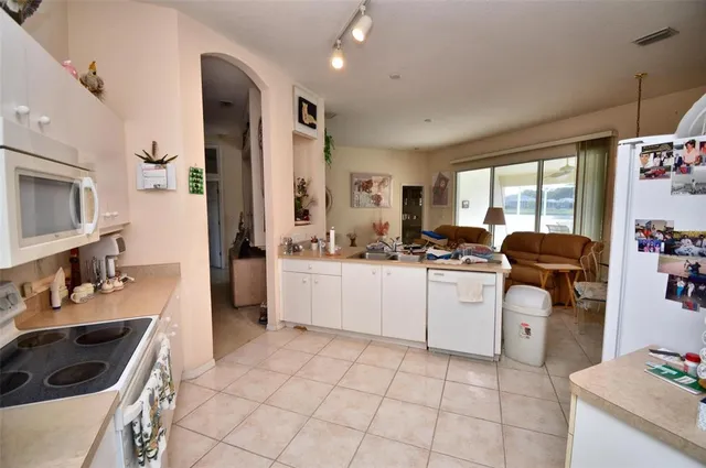a kitchen with a sink cabinets and window