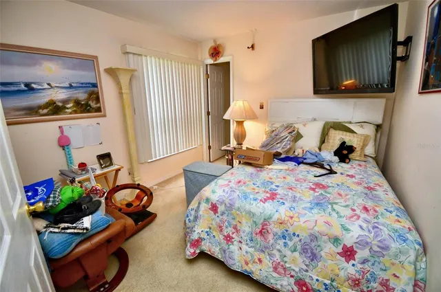 a bedroom with bed and a window