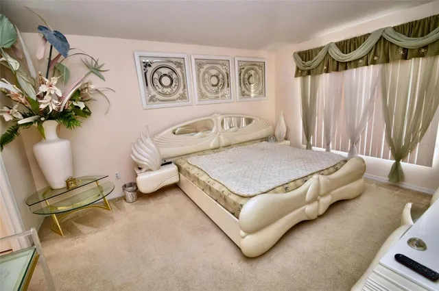 a bedroom with a bed and a chair