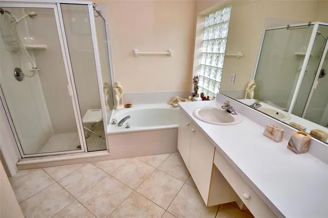 a bathroom with a tub sink and mirror