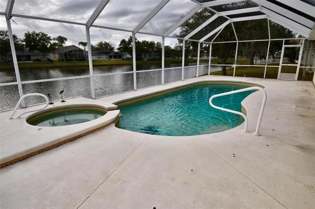 a view of a swimming pool with a yard
