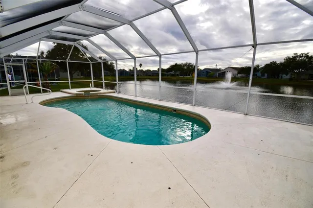 a view of a swimming pool with a yard in back