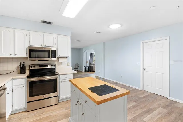 a view of a kitchen with microwave and cabinets