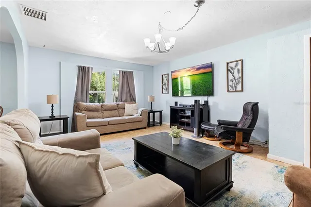 a living room with fireplace furniture and a flat screen tv