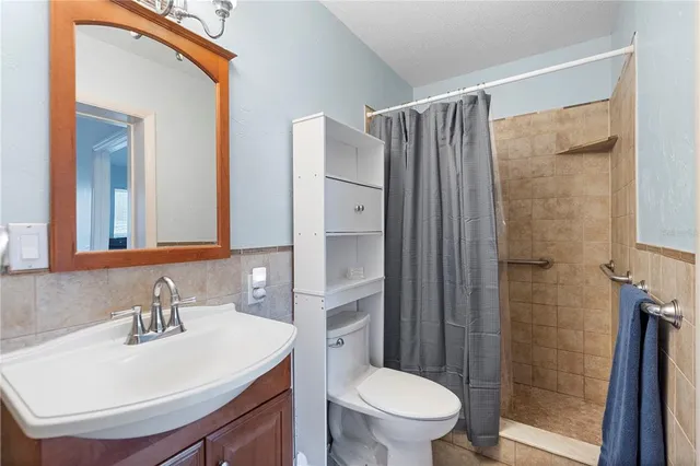 a white toilet sitting next to a bathroom sink