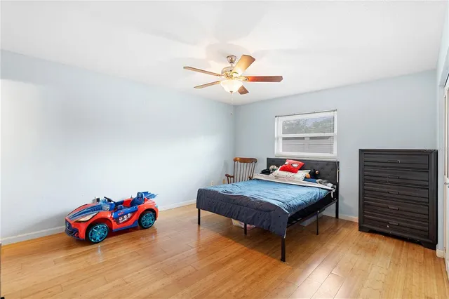 a living room with a bed furniture and a flat screen tv