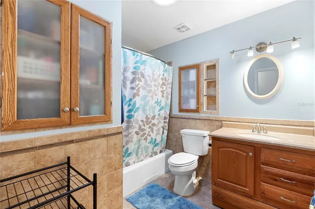 a utility room with dryer washer and a view of living room