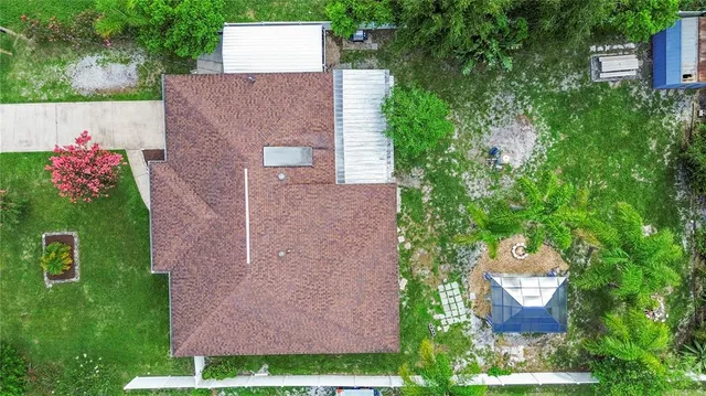 a patio with a table and chairs and a barbeque