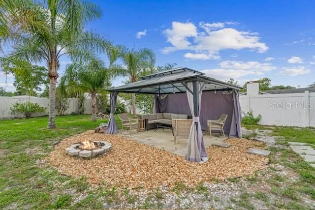 a view of a backyard with sitting area