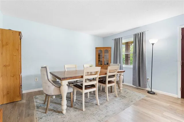 a view of a dining room with furniture and window