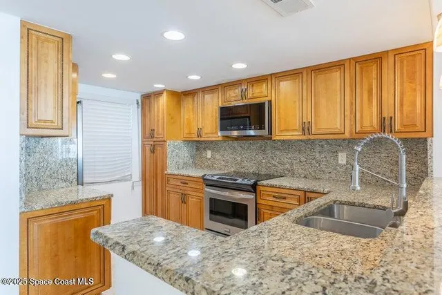 a living room with furniture and a glass door shower