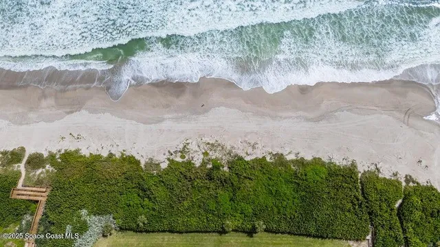 a dining room with furniture a chandelier and window