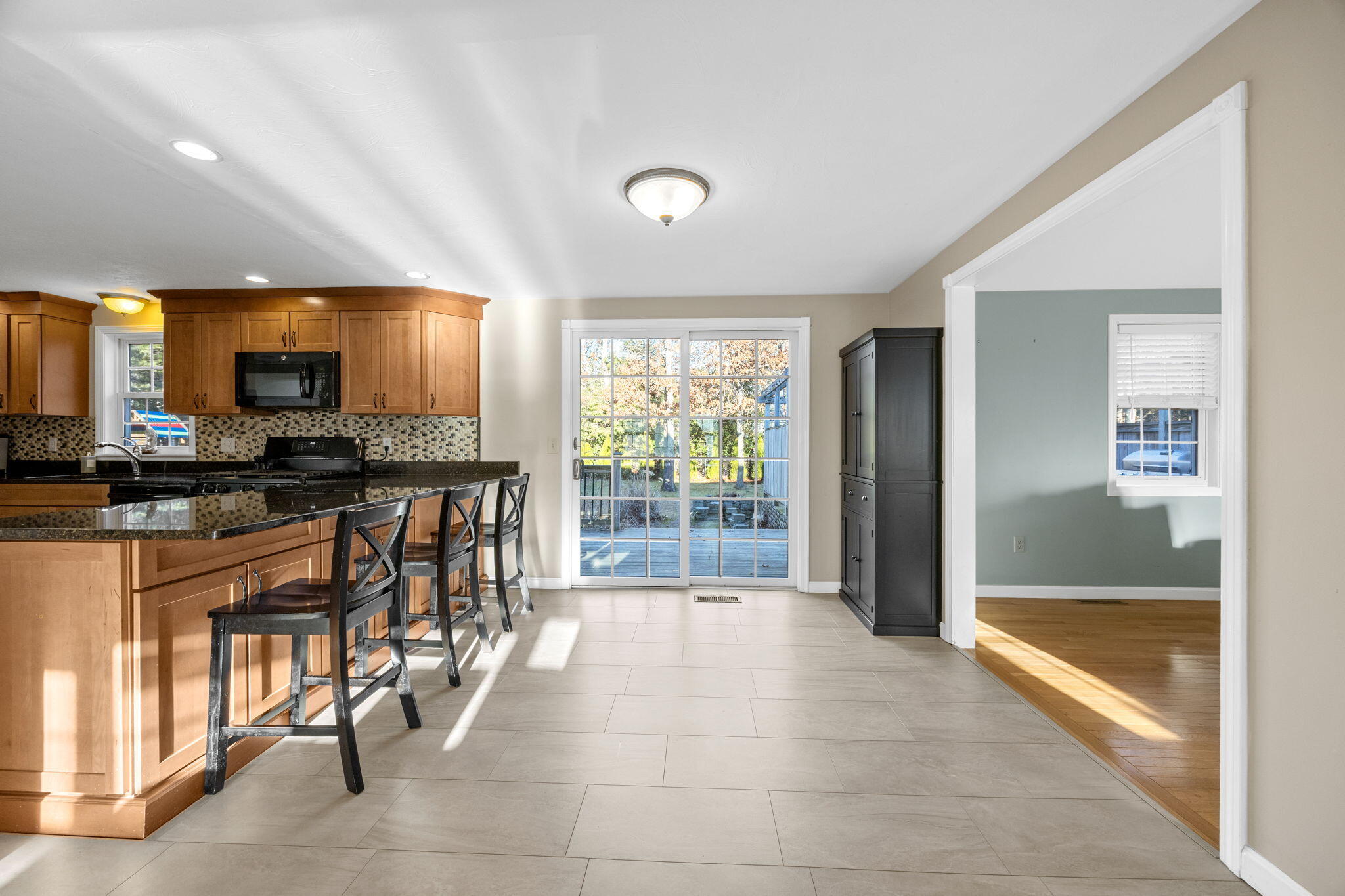 30 Flicker Lane Marstons Mills, MA 02648 - Photo 12 of 47 a large kitchen with granite countertop a stove a sink a dining table and chairs