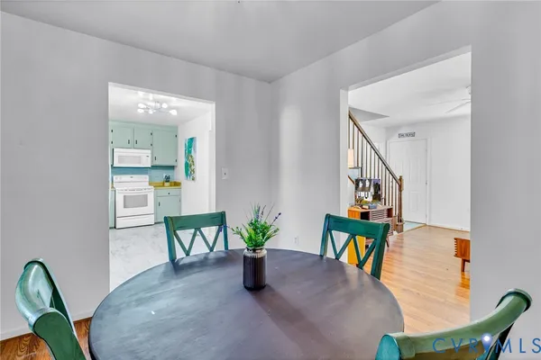 a dining room with furniture and wooden floor