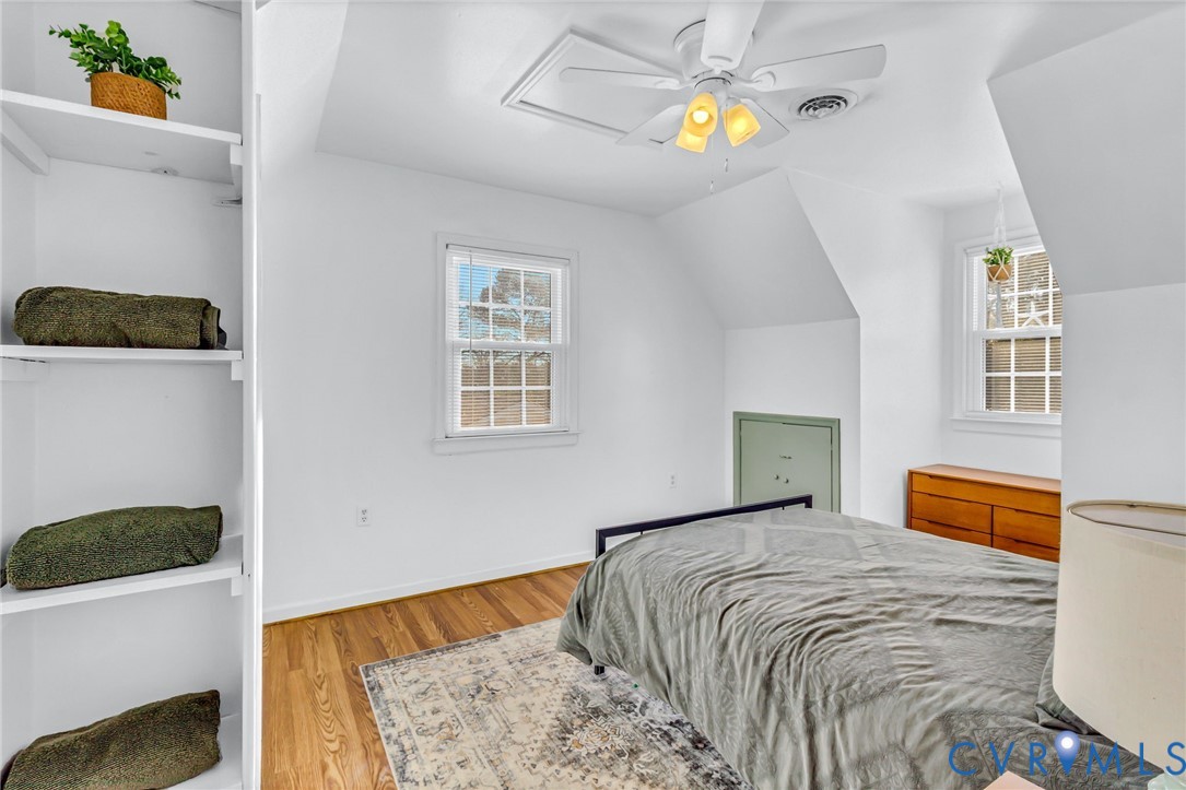 151 Badger Road Deltaville, VA 23043 - Photo 18 of 43 a bedroom with a bed and a chandelier