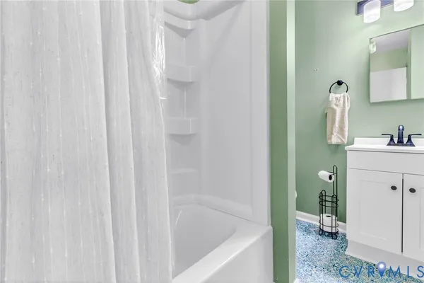 a bathroom with a bathtub a sink and a shower