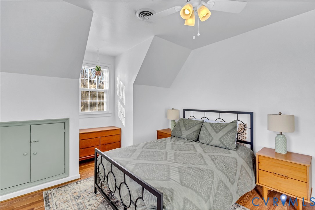 151 Badger Road Deltaville, VA 23043 - Photo 20 of 43 a bedroom with a bed and a chandelier