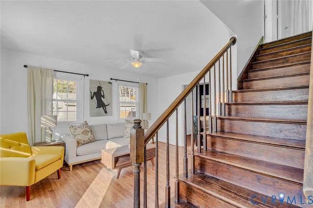 a living room with furniture and stairs