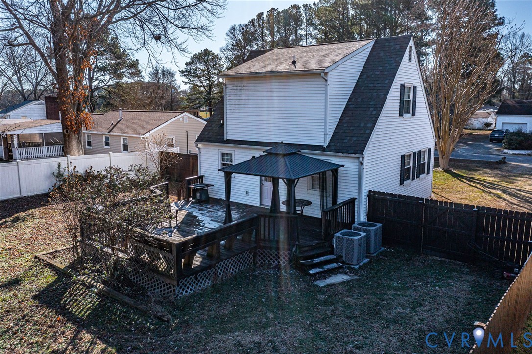 151 Badger Road Deltaville, VA 23043 - Photo 31 of 43 a view of a roof deck with table and chairs with wooden floor and fence