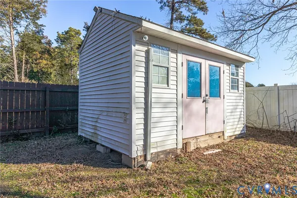 a view of a house with a yard and wooden fence