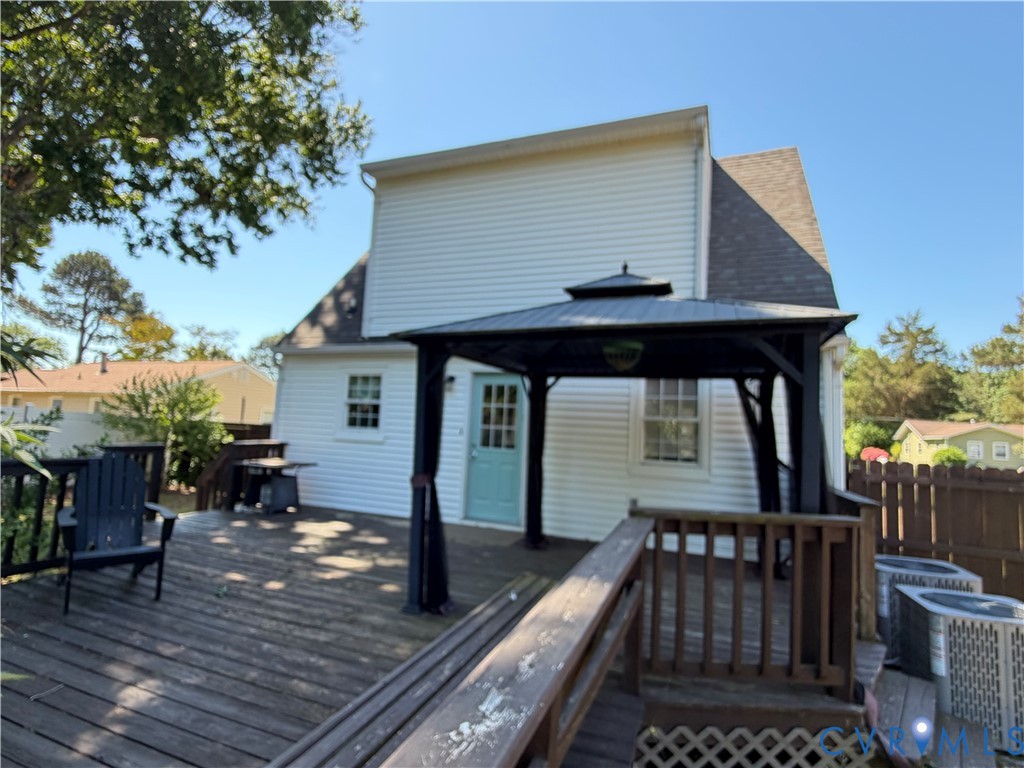 151 Badger Road Deltaville, VA 23043 - Photo 34 of 43 a view of house with deck and outdoor seating