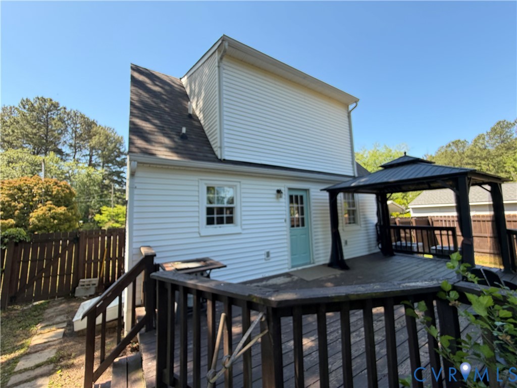 151 Badger Road Deltaville, VA 23043 - Photo 35 of 43 a side view of house with wooden deck and furniture