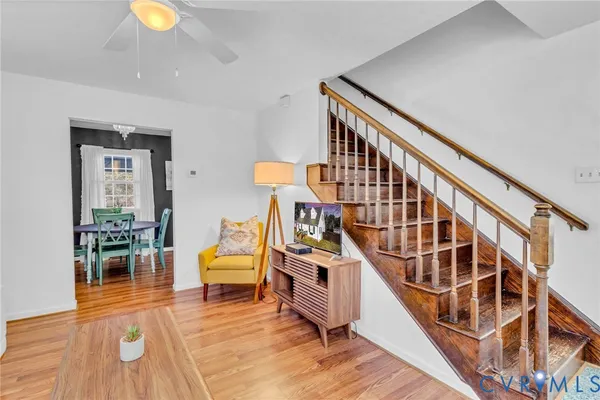 a living room with furniture and wooden floor