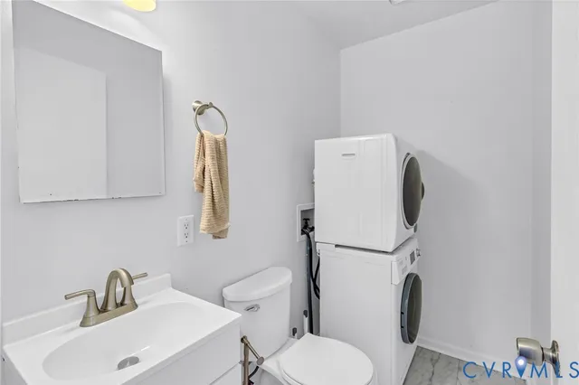 a white toilet sitting next to a bathroom sink