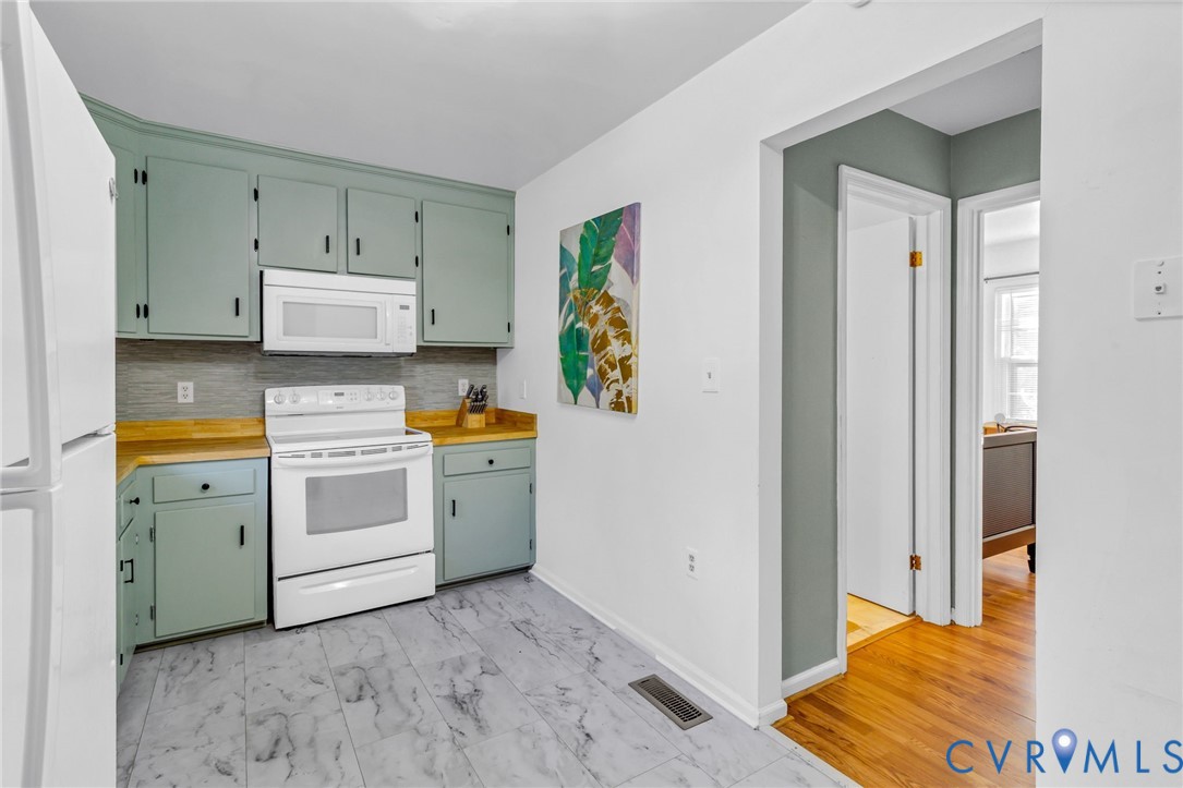 151 Badger Road Deltaville, VA 23043 - Photo 10 of 39 Kitchen featuring white appliances, tasteful backs