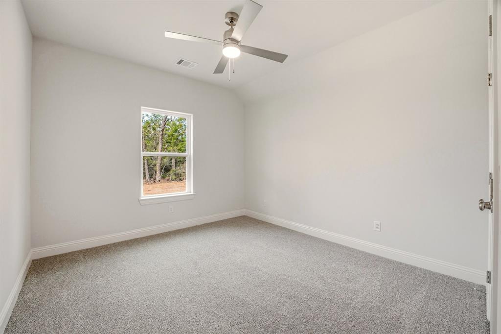 2017 Forest Bridge Azle, TX 76020 - Photo 26 of 30 Empty room featuring light colored carpet, ceiling fan, and vaulted ceiling
