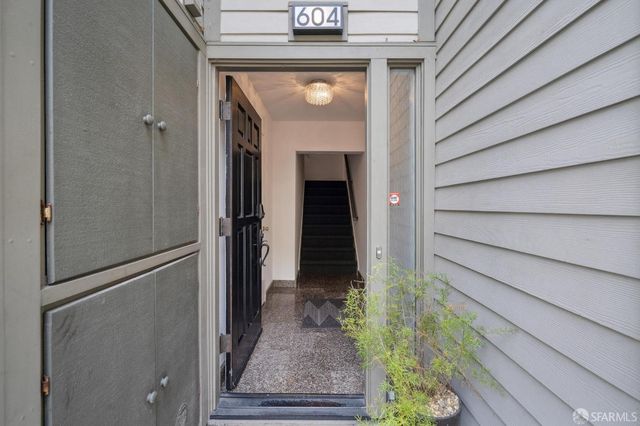a living room with furniture large window and fireplace