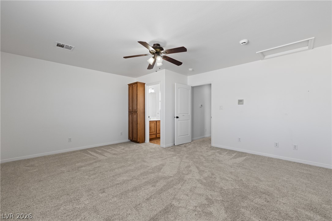 575 Gann Avenue Logandale, NV 89021 - Photo 47 of 75 A spacious secondary room offers versatility for various uses, featuring a ceiling fan for comfort.